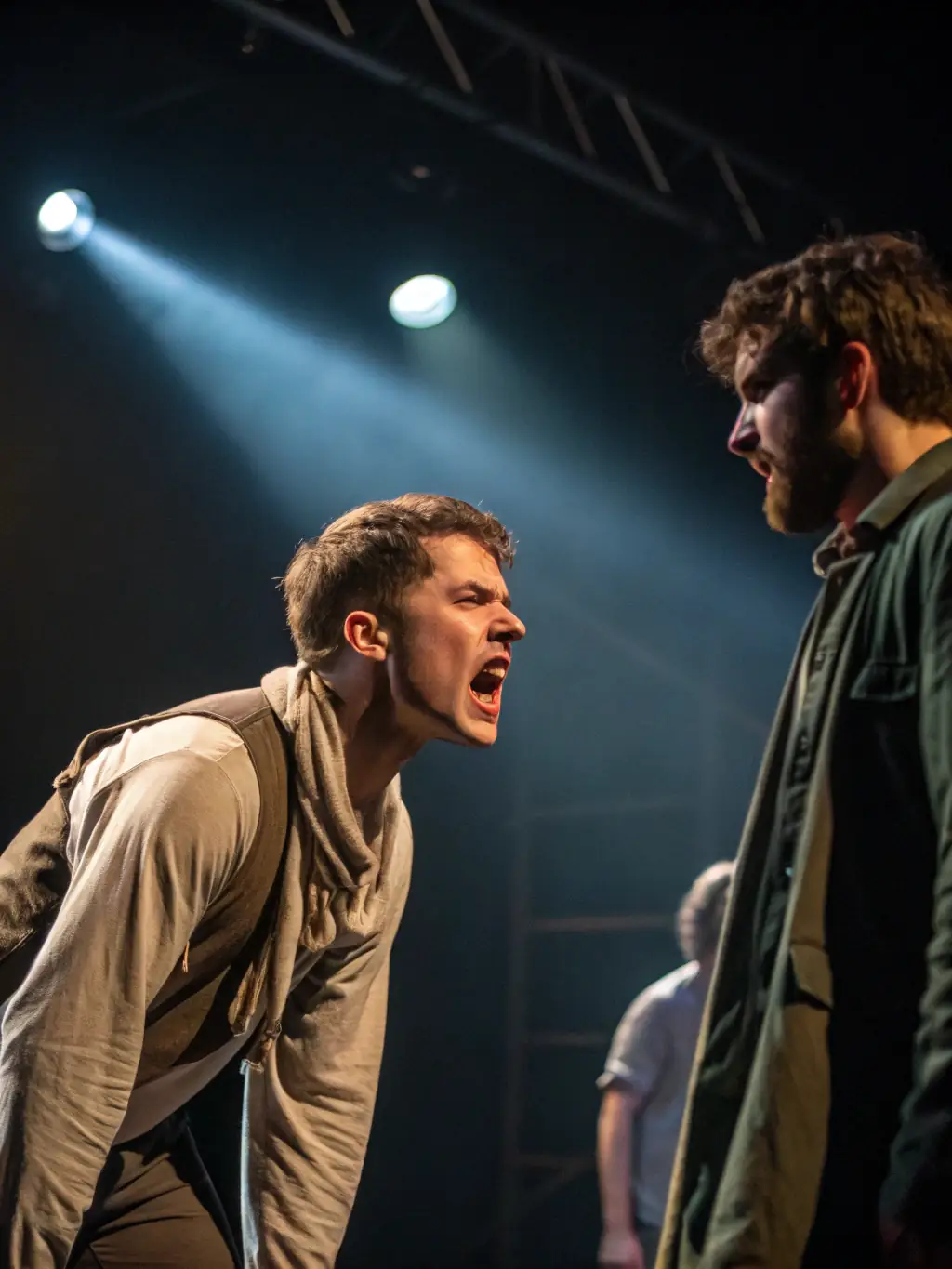A dynamic image of actors rehearsing a scene from a play, highlighting intense emotions and dramatic expressions, set against a minimalist stage backdrop, representing the theatrical arts focus of ASSOCIATION CORPS ET GRAPHIE.